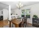 Bright dining area with a view through a large window, offering a modern chandelier and a gray rug at 131 Abacos Ct, Clayton, NC 27520