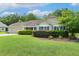 Charming single-story home featuring a well-manicured lawn, attached garage, and lush landscaping at 131 Abacos Ct, Clayton, NC 27520