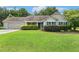 Charming single-story home featuring a well-manicured lawn, attached garage, and lush landscaping at 131 Abacos Ct, Clayton, NC 27520