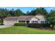 Charming single-story home featuring an attached garage, manicured lawn, and verdant landscaping at 131 Abacos Ct, Clayton, NC 27520