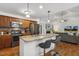 Open kitchen with stainless steel appliances, breakfast bar, and a view of the living area at 131 Abacos Ct, Clayton, NC 27520
