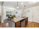 Kitchen island with sink, stainless steel dishwasher, and view of the dining area at 131 Abacos Ct, Clayton, NC 27520