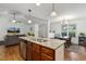 Spacious kitchen island with stainless steel dishwasher, leading to the living and dining areas at 131 Abacos Ct, Clayton, NC 27520