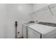 Functional laundry room featuring modern washer, dryer, and storage rack at 131 Abacos Ct, Clayton, NC 27520