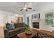 Comfortable living room features a vaulted ceiling, a fireplace and an adjacent modern kitchen at 131 Abacos Ct, Clayton, NC 27520