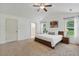 Spacious main bedroom with abundant natural light, carpeted floors, and ensuite access at 131 Abacos Ct, Clayton, NC 27520