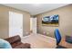Cozy office with a desk, chair, comfortable recliner and a wall-mounted tv at 131 Abacos Ct, Clayton, NC 27520