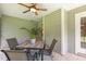 Covered patio featuring a ceiling fan and an outdoor dining set at 131 Abacos Ct, Clayton, NC 27520