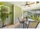 Relaxing screened porch with ceiling fan, tile flooring, and a table perfect for outdoor dining at 131 Abacos Ct, Clayton, NC 27520