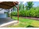 Covered patio and grassy lawn area with fencing for a safe play space at 1363 Brown Velvet Ln, Apex, NC 27523
