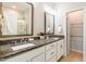 Spacious bathroom featuring double sinks with granite countertops, white cabinetry, and a separate shower at 1363 Brown Velvet Ln, Apex, NC 27523