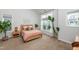 Bright bedroom with large windows, neutral carpet, and stylish decor and plants throughout the space at 1363 Brown Velvet Ln, Apex, NC 27523