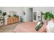 A bedroom with neutral carpet, soft lighting, and an ensuite bathroom. Plants decorate the room at 1363 Brown Velvet Ln, Apex, NC 27523