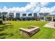 Community common area featuring manicured lawn and stone fire pit with picturesque homes in the background at 1363 Brown Velvet Ln, Apex, NC 27523