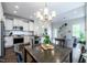 Open-concept dining area adjacent to a modern kitchen and comfortable living space at 1363 Brown Velvet Ln, Apex, NC 27523