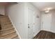 Light and bright entryway featuring coat hooks, staircase with carpet, and vinyl wood flooring at 1363 Brown Velvet Ln, Apex, NC 27523