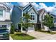 Side view of a two-story home with an attached garage, complemented by mature landscaping at 1363 Brown Velvet Ln, Apex, NC 27523