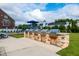 Community grilling area with several stainless steel grills, stone accents, and a nearby playground at 1363 Brown Velvet Ln, Apex, NC 27523