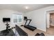 Bright home gym features carpet floors, exercise equipment, and natural light from the window at 1363 Brown Velvet Ln, Apex, NC 27523