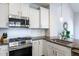 Well-lit kitchen featuring granite countertops, stainless steel appliances, and ample cabinet space at 1363 Brown Velvet Ln, Apex, NC 27523