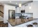 Modern kitchen with granite countertops, stainless steel appliances, and white cabinets at 1363 Brown Velvet Ln, Apex, NC 27523