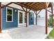 Covered patio, with wood supports, provides a serene spot to sit outside in shade at 1363 Brown Velvet Ln, Apex, NC 27523