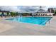 Community pool with blue water, plenty of lounge seating, and a lovely clubhouse at 1363 Brown Velvet Ln, Apex, NC 27523