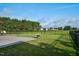 Lush backyard featuring green lawn and a view of the neighboring houses beyond the black metal fence at 1409 Sage Tree Dr, Zebulon, NC 27597