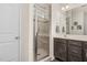 Bathroom featuring tiled shower with glass door and updated vanity with sink at 1409 Sage Tree Dr, Zebulon, NC 27597