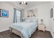 Bedroom featuring a queen bed with blue decor and laminate flooring at 1409 Sage Tree Dr, Zebulon, NC 27597