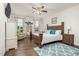 Cozy bedroom with ceiling fan, wood floor, and large windows showing an inviting outdoor view at 1409 Sage Tree Dr, Zebulon, NC 27597