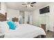 Bedroom featuring white bedding with decorative pillows and wall-mounted television and spacious layout at 1409 Sage Tree Dr, Zebulon, NC 27597