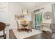 Charming dining area with stylish chairs, an elegant light fixture, and patio access at 1409 Sage Tree Dr, Zebulon, NC 27597