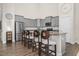 Stylish kitchen with gray cabinets, stainless steel appliances, and a breakfast bar at 1409 Sage Tree Dr, Zebulon, NC 27597