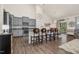 Modern kitchen with gray cabinetry, stainless steel appliances, and a breakfast bar area at 1409 Sage Tree Dr, Zebulon, NC 27597