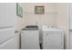 Bright laundry room featuring a modern, white washer and dryer set at 1409 Sage Tree Dr, Zebulon, NC 27597