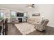Bright and airy living room with fireplace, large windows, ceiling fan and stylish decor at 1409 Sage Tree Dr, Zebulon, NC 27597