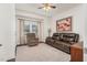 Cozy living room features a comfy leather couch and neutral carpet at 1409 Sage Tree Dr, Zebulon, NC 27597