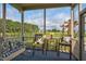 Inviting screened porch with outdoor seating and a table offering views of the expansive backyard at 1409 Sage Tree Dr, Zebulon, NC 27597