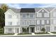 Charming townhome with varied textures showcases a welcoming front entrance and modern curb appeal at 1426 Jay Rd, Knightdale, NC 27545