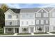 New three-story townhome with traditional siding and professionally landscaped front yard at 1430 Jay Rd, Knightdale, NC 27545
