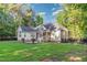 Backyard features a large, grassy area with mature trees at 15 Cole Creek Way, Franklinton, NC 27525