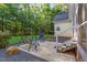 Backyard features a stone patio with a swing set and chairs at 15 Cole Creek Way, Franklinton, NC 27525