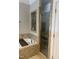 Bathroom showcasing a tiled shower with glass doors, a soaking tub and a small display nook at 15 Cole Creek Way, Franklinton, NC 27525