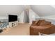 This bonus room features a tan sofa and a TV at 15 Cole Creek Way, Franklinton, NC 27525