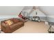 This bonus room features a tan sofa and a bed at 15 Cole Creek Way, Franklinton, NC 27525