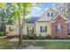 Inviting home with a covered porch, rocking chairs, and attractive landscaping at 15 Cole Creek Way, Franklinton, NC 27525