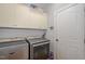 Functional laundry room with modern washer and dryer units and ample storage at 15 Cole Creek Way, Franklinton, NC 27525