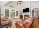 Cozy living room with a fireplace, large windows, and comfortable seating at 15 Cole Creek Way, Franklinton, NC 27525