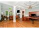 Open-concept living room with hardwood floors, fireplace, and coffered ceiling at 15 Cole Creek Way, Franklinton, NC 27525